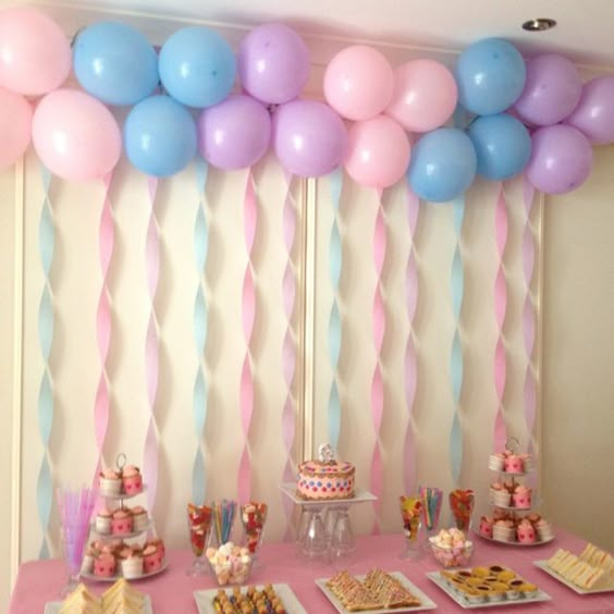 Decora el fondo de tu mesa de postres para una fiesta infantil con globos y serpentinas. #DecoracionMesaDePostres