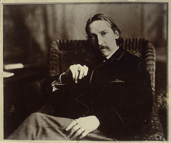 R. L. Stevenson (seated on chair with left leg over knee, left hand on left…