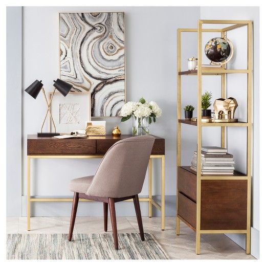 Bring a modern update to your home office decor with the Antwerp Walnut Desk from Project 62Â. This rectangular desk combines modern elegance with sleek practicality, thanks to a walnut finish top and brass legs combined with two handy drawers and a large work surface. Try placing it atop a large off-white rug, pulling in a complementary desk chair and adding a dramatic floor lamp to complete the modern look. To further enhance the space, incorporate pops of color from plants and art...