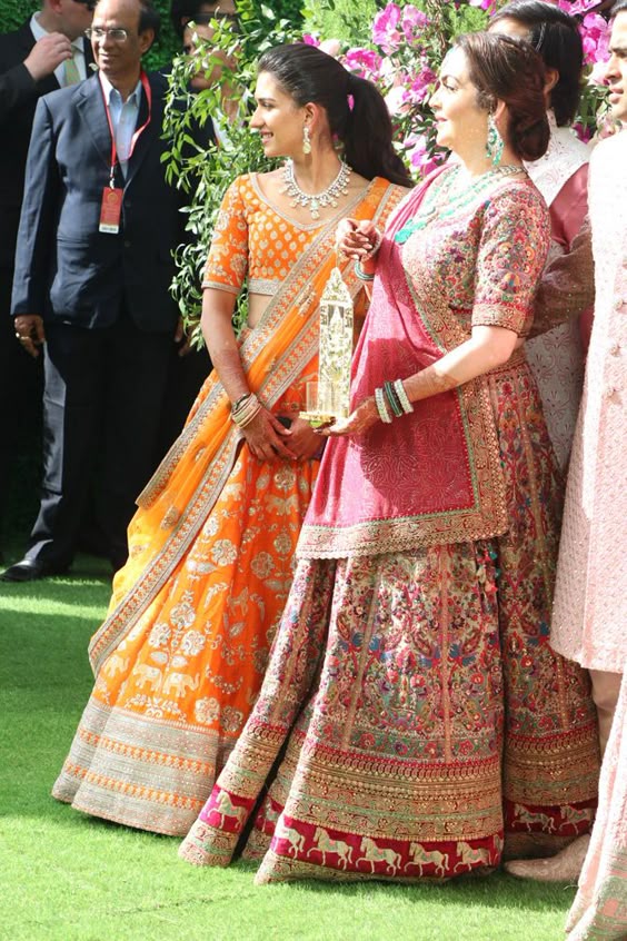 Radhika Merchant in Orange lehenga at Akash Ambani wedding, Designer lehenga choli, lehenga choli for festive, dsigner lehenga choli for occasion, lehenga choli for function, Silk short kurti style lehenga choli, fresh collection in lehenga choli, pastel colour lehenga choli, winter collection lehenga choli, latest design lehenga choli 2019, shop online designer silk lehenga choli, celebrity lehenga design