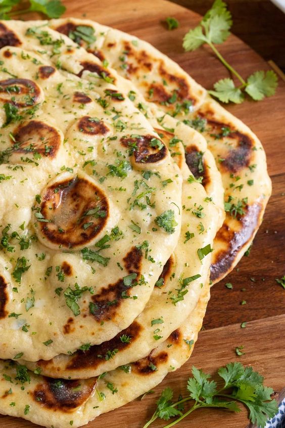 This easy Homemade Naan is soft, puffy and so delicious! It will rival the naan at your favorite Indian restaurant! Make it yourself with minimal effort! #easynaan, #nomixernaan, #onebowlnaan