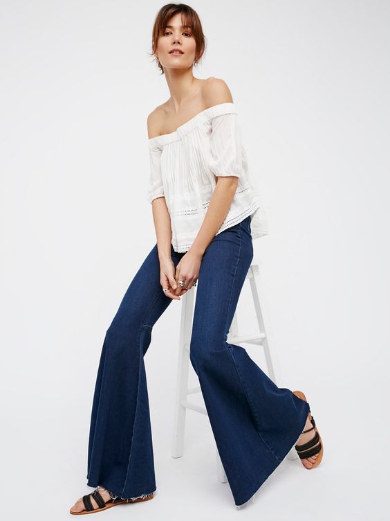 Just Float On Flare | In a clean silhouette with a flat front these high-rise jeans feature a flared leg with a raw hem. * Back seam detailing on the knee. * Super soft and super stretch fabric. * Back pockets. * Button closure and zip fly.