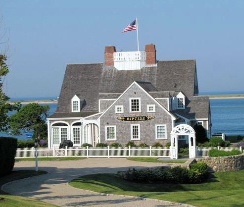 coastal shingle cottage with widow's walk, white picket fence