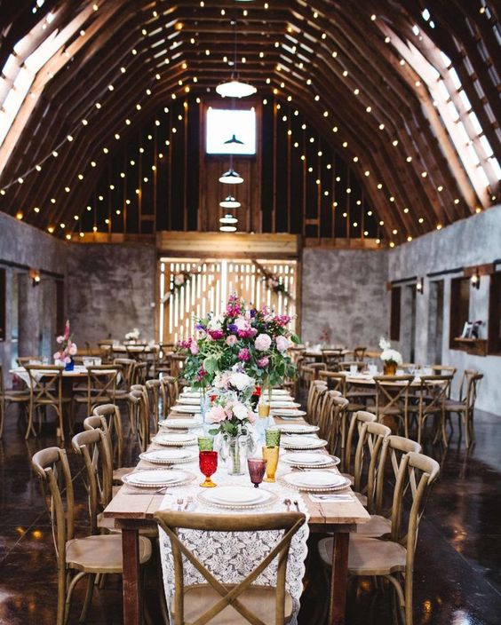 These Gorgeous Mountain Wedding Venues Will Blow You Away | Martha Stewart Weddings - Overlook Barn in Banner Elk, North Carolina. After renovating an old barn for their nuptials, the owners decided to rent it to others dreaming of a Blue Ridge Mountain event. Twinkling lights hang from 30-foot rafters in the gray-walled space, which is outfitted with reclaimed-wood tables and cross-back chairs.
