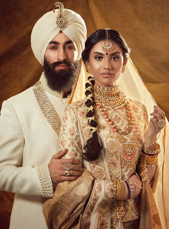 ivory sherwani matching the white and gold detailed bridal lehenga.