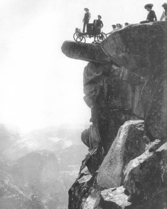 Locomobile steam car on Overhanging Rock in 1900. This was the first automobile to enter Yosemite Valley. Oliver Lippincott drove up the steep, winding road to Glacier Point. The next morning it was hauled onto Overhanging Rock by ropes for this famous photograph.