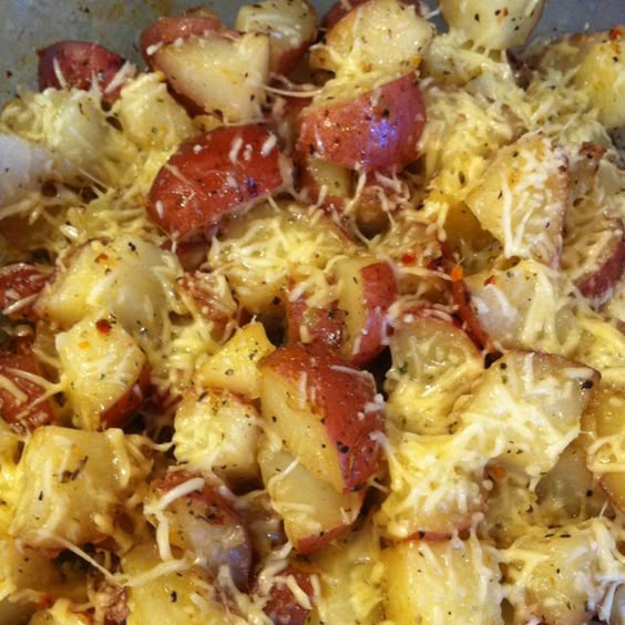 Zesty Italian Potatoes! Yummy! Red potatoes cubed with skin left on, drizzle with extra virgin olive oil, coat with a package of zesty Italian dressing mix and stir to coat, add minced onion for flavor, salt and pepper to taste. Cook 400 degree oven for 45 minutes or until tender. Top with grates Parmesan cheese.