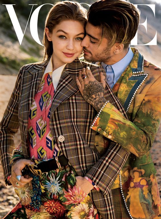 Gucci Editorials On the cover of Vogue Magazineââ¬â¢s August issue, Gigi Hadid and Zayn Malik wearing looks from the Gucci SS 2018 collection by Alessandro Michele, including a check tailored jacket, GG Wallpaper print silk shirt, GG belt and floral pants, and a printed Heritage jacket with patch and crystal details. Stylist: Tonne Goodman Photography: Inez and Vinoodh