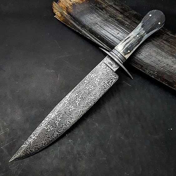 10" Snowflake Damascus with Firestorm edge, ladder pattern Damascus guard, crushed W's Damascus spacer and twisted Damascus frame engraved stainless finial and some of the prettiest ancient mammoth ivory I have seen. Now for the sheath. I think black Alligator.