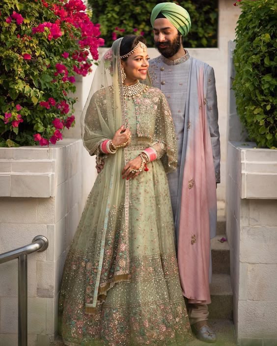 pastel green bridal lehenga with pastel blue sherwani.