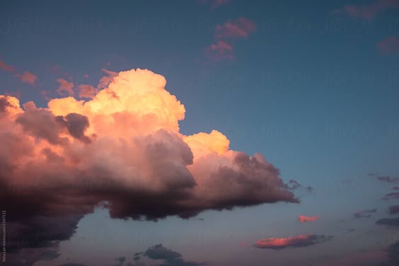 "Cumulus Clouds At Sunset" by Stocksy Contributor "Vera Lair"