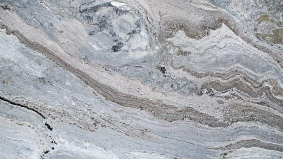 Blue Fantasy Quartzite Is a veiny stone with areas of sedimentary compound. If your looking for a stone that will stand out, similar to a piece of art, then Blue Fantasy could be your perfect countertop option.