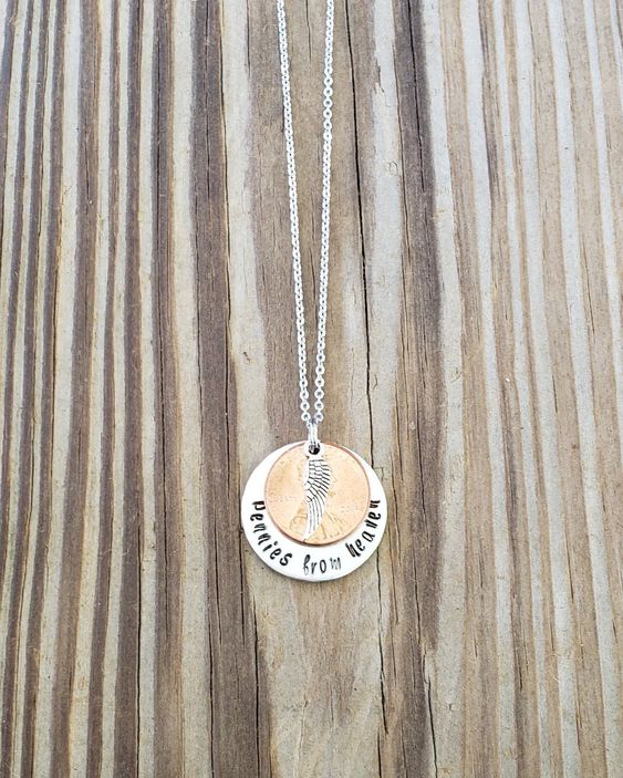 "Hand stamped pennies from heaven necklace on an 18\\" stainless steel chain. Hand stamped by me on a 1\\" aluminum round. Please provide penny year requested if you have a particular year you\'d like. Pennies earlier than 1985(ish) are harder to come by, as I use pennies that I have laying around the house. You can request years prior, but if you do, please leave another year you\'d be okay with me using in case I can\'t find your first choice! This listing is for ONE necklace. Please leave a font c