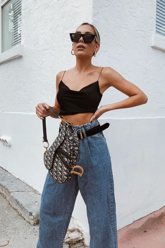 Image ©imnotsorrydarling| SUMMER STREET STYLE OUTFIT #9. BLACK CROPPED TANK TOP + SLOUCHY JEANS + SUNNIES + DIOR CANVAS SADDLE BAG | Street style is very complex because it does not cover one style of dressing, but encompasses a whole range of styles: grunge, casual, boho, and sneakers outfits. Spring street fashion and summer street style are our favorite, create an edgy street style outfit. #streetoutfitsummer #streetstyle #streetfashion