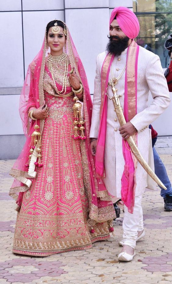 pink bridal lehenga with matching shawl and white sherwani and pagdi.