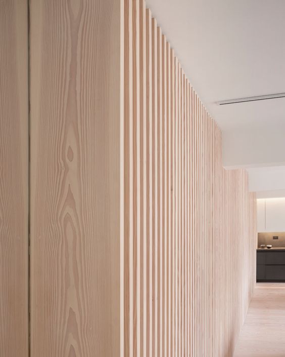 Interior Design Ideas – This Wood Batten Wall Provides A Hiding Place For Doors And Appliances