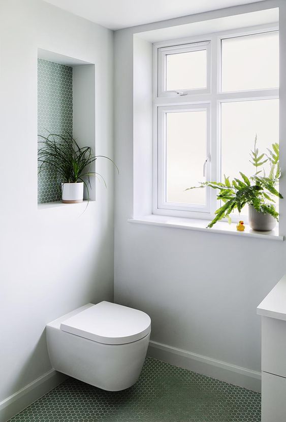 A Recessed Shelf Lined With Penny Tiles Adds A Pop Of Color To This Bathroom