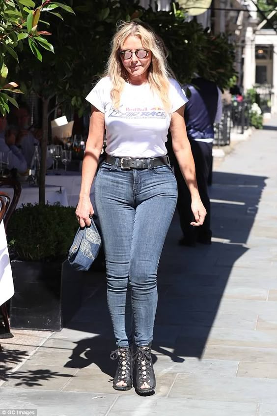 Carol Vorderman shows off her curves in VERY tight jeans in London