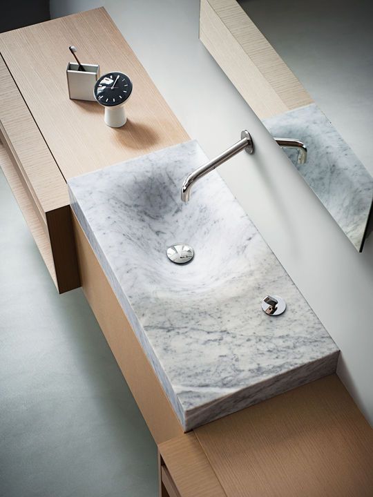 815 Washbasin by Benedini Associati for Agape Design The asymmetrical form of Agape’s Cararra marble sink is modeled after the effect of water eroding stone. This originally appeared in 815 Washbasin.
