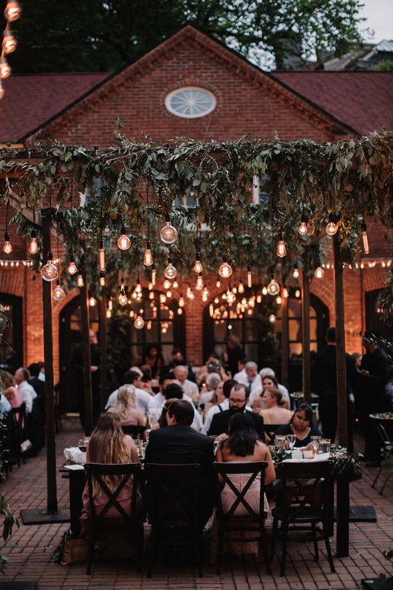 Greenery and edison light bulbs make for a romantic al fresco dinner party! photo by brightwood photography.