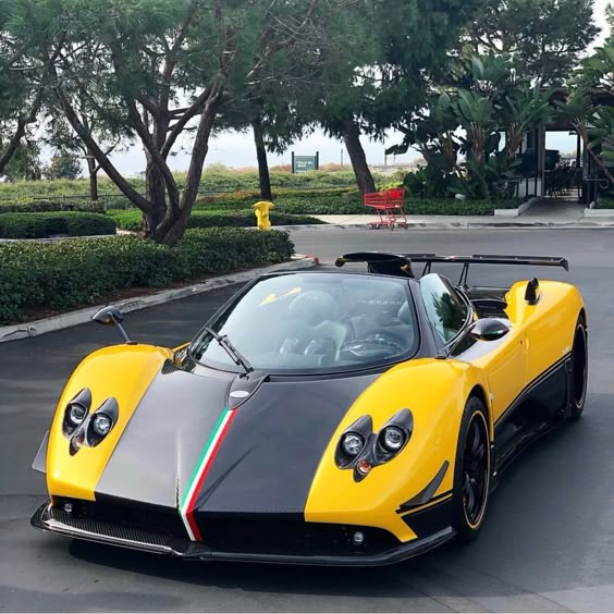 Pagani Zonda Cinque Roadster painted in Giallo w/ exposed carbon fiber and a Tricolore central stripe Photo taken by: @jchwa on Instagram Owned by: @dan_am_i on Instagram