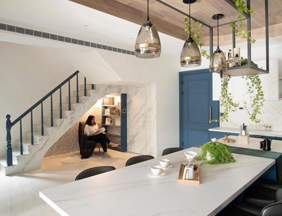 A Small Reading Nook Under The Stairs Makes Use Of An Otherwise Awkward Space