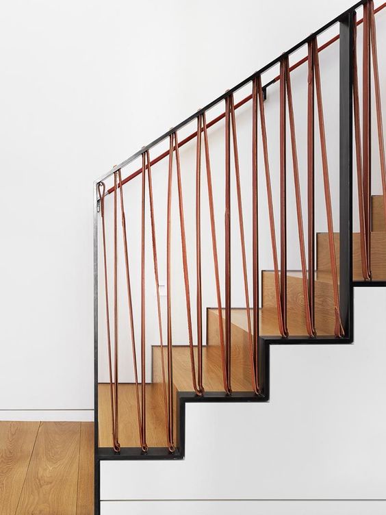 A Stair Railing Made From Steel And Leather Gives A Modern Industrial Look To This Home