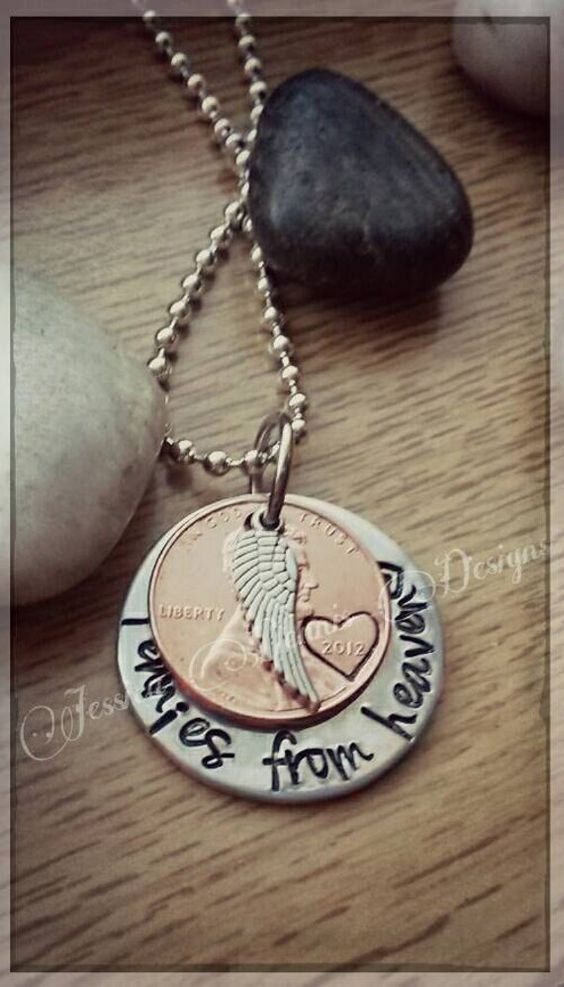 "It is often a belief that our passed loved ones will leave pennies or other coins in unusual places along our paths as a sign that they are watching over us. This necklace is a special reminder that our loved ones are always watching over us. This custom designed necklace is a nice piece of memorial jewelry that will easily become your go-to piece. I\'ve hand stamped a 1\\" silver disc to say \\"Pennies from Heaven\\" and added a penny with a heart stamp around the year, along with a small angel
