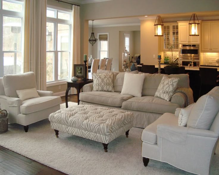 Neutral Living Room With Overstuffed Beige Sofa Beige Linen Armchairs And A Tufted Ottoman Neutral Living Room With Overstuffed Beige Sofa Beige Linen Armchairs And A Tufted Ottoman