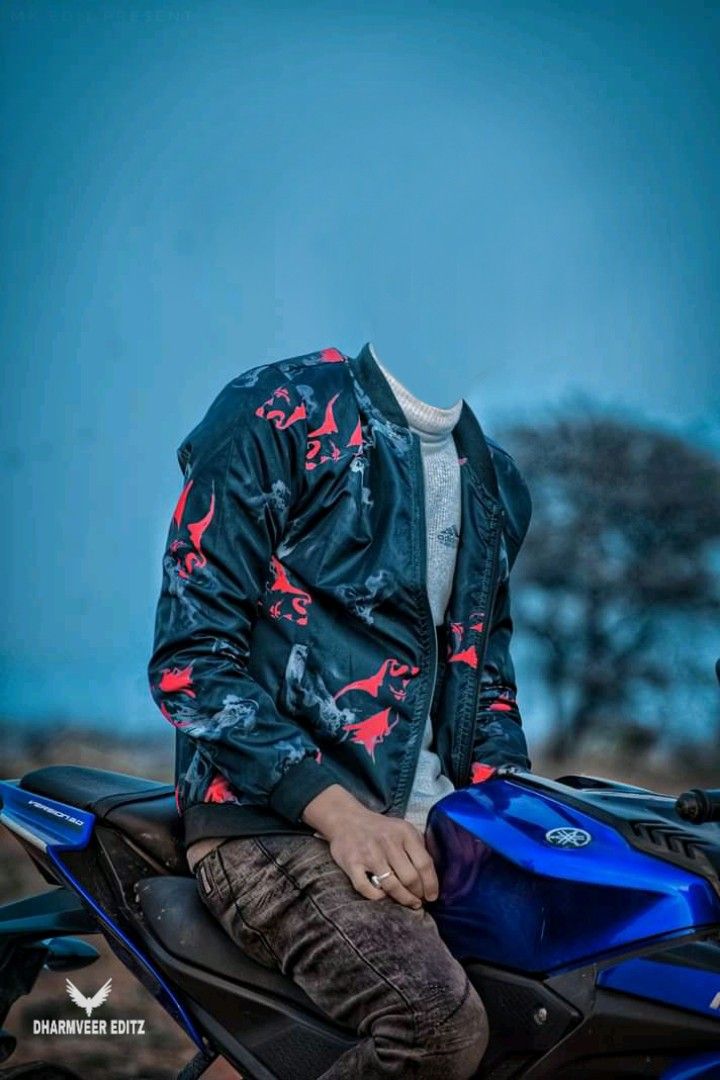 a man sitting on the back of a blue and black motorcycle wearing a leather jacket