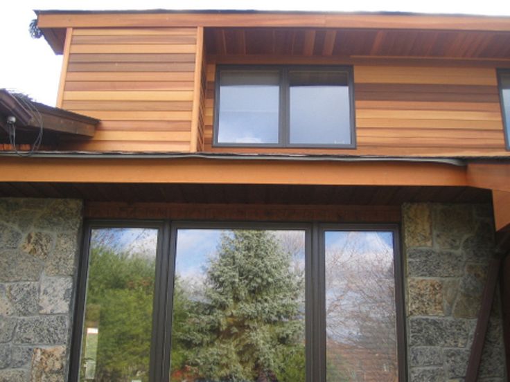 modern cedar horizontal wood siding home with dark shingles and modern cedar horizontal wood siding home with dark shingles and