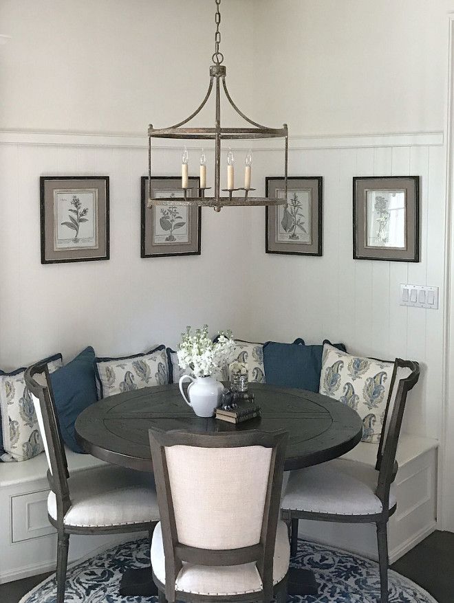 a dinning room table with four chairs and a bench in front of the table