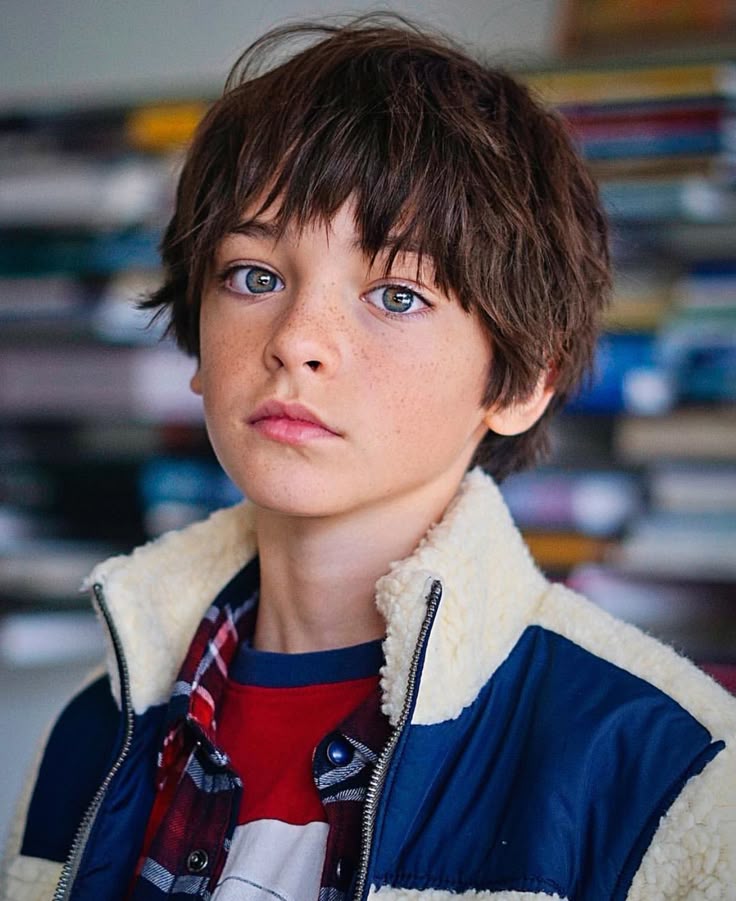 A Close Up Of A Person Wearing A Jacket And Looking Off To The Side With A Serious Look On His Face