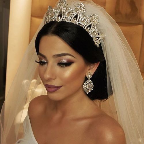 A beautiful princess Bride wearing a pretty diamond tiara.