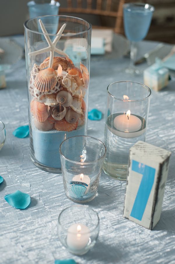 Adorable centerpieces & table numbers from a beach themed wedding! More on  the blog!