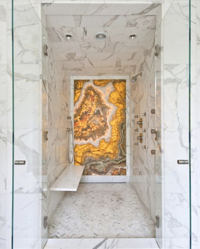 a bathroom with marble floors and walls