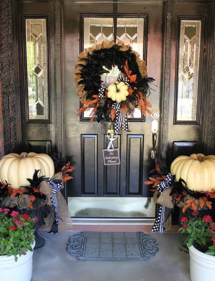 fall front porch decoration with white pumpkin wreath and pumpkins