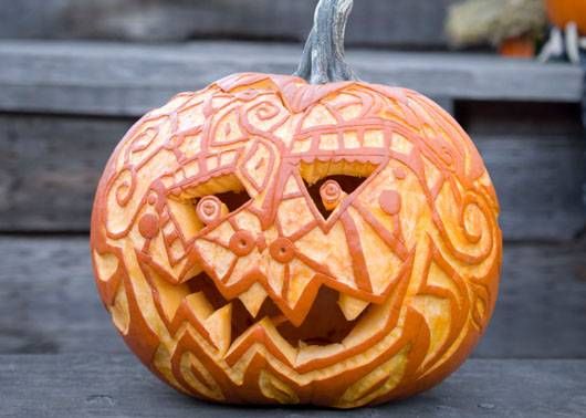 for those with an artistic edge this pumpkin carving idea is just for you this goofy jack o lantern is covered in shallow carvings that showcase the - Creative Halloween Pumpkin Carving Ideas for those with an artistic edge this pumpkin carving idea is just for you this goofy jack o lantern is covered in shallow carvings that showcase the - Creative Halloween Pumpkin Carving Ideas