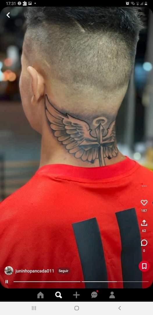 The Back Of A Man s Head With A Tattoo On His Neck And Chest the-back-of-a-man-s-head-with-a-tattoo-on-his-neck-and-chest