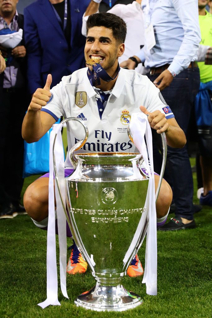 Marco Asensio Of Real Madrid Poses With The Trophy Following The