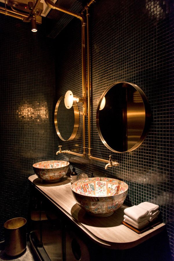 a bathroom with two sinks and mirrors in the wall, along with other items on the counter