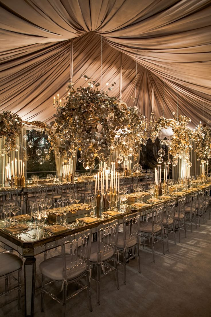 a long table is set up with candles and place settings for an elegant wedding reception