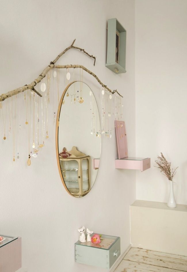 a white room with a mirror and some decorations on the wall