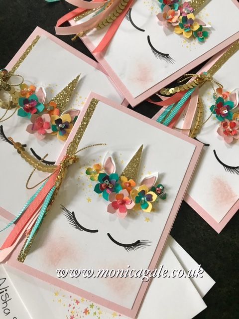 three cards with flowers and feathers on them