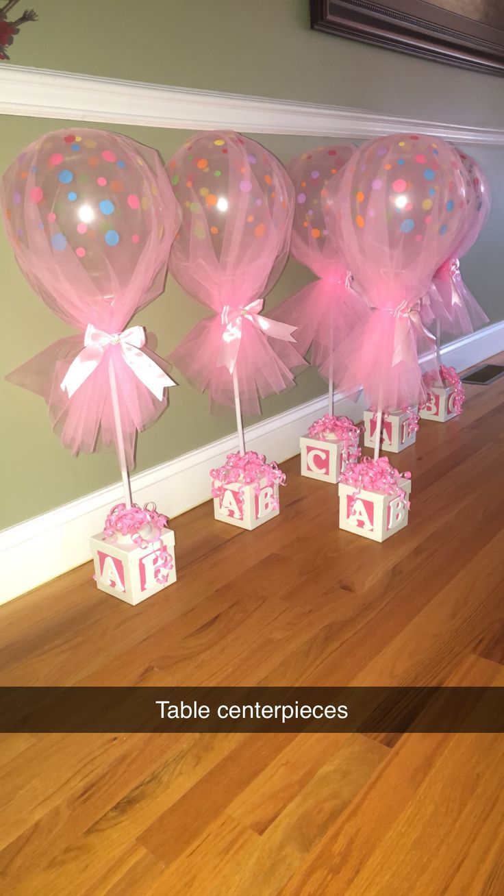 Baby shower table centerpieces filled with pink candies. Winner of bingo at each...