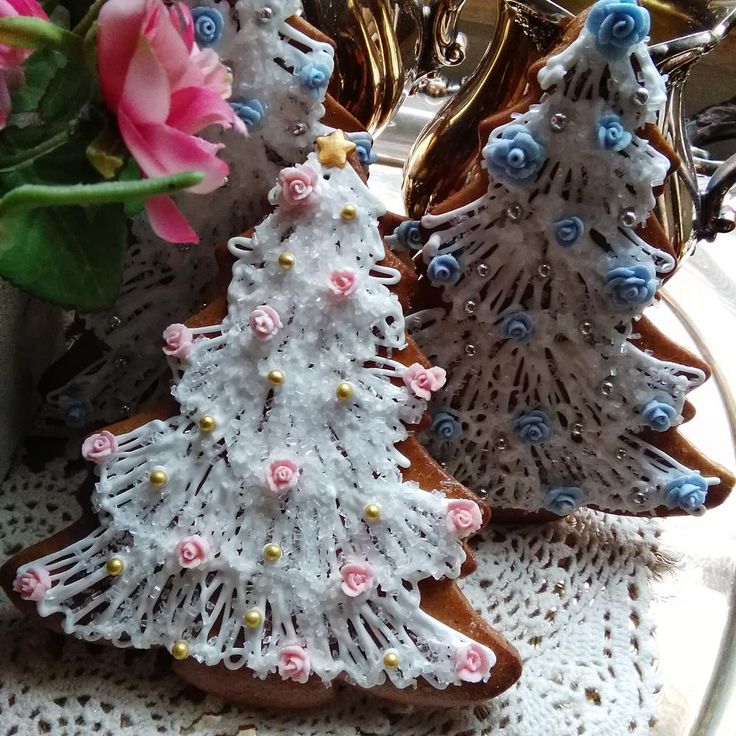 iced sugar cookies decorated as snow covered evergreen trees roses christmas cookies