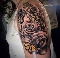 a woman with a butterfly and roses tattoo on her arm