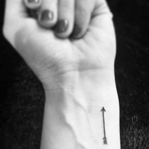 Little arrow tattoo on Hales’ wrist. The arrow reminds her to “Just