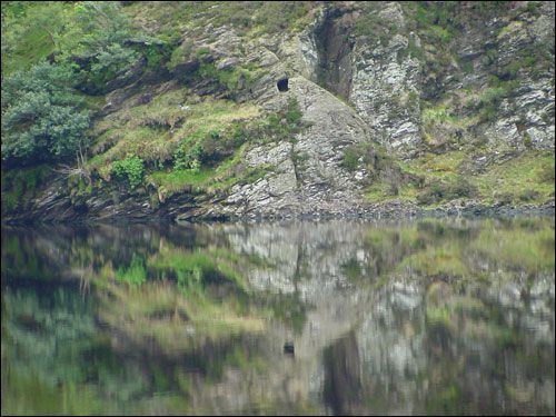 photo St Kevin's Bed st kevin s bed the small square opening in the cliff is a small cave to the east of temple ne skellig the entrance is about 8 metres ireland