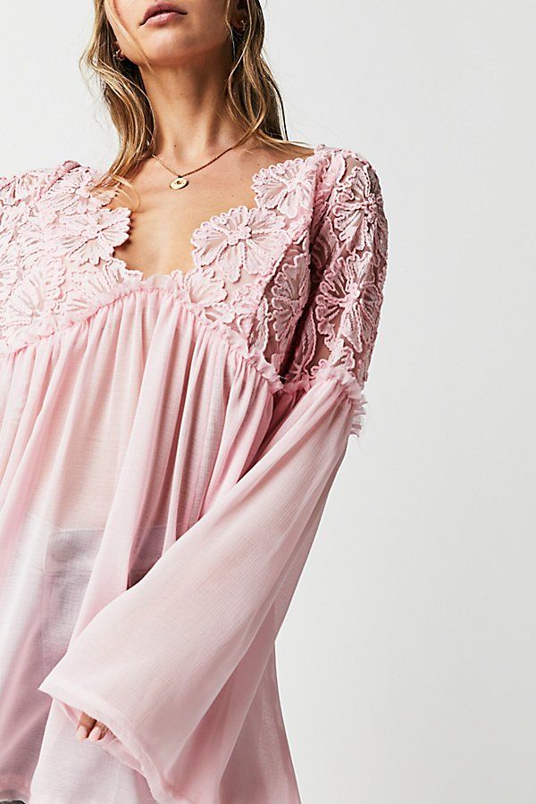 Forever femme in a babydoll-inspired silhouette, this stunning tunic